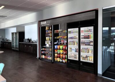 Deluxe vending display at Breakme corporate breakroom with snack shelves and coolers