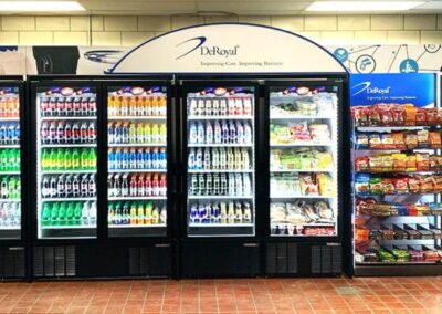 Deluxe vending fixture at DeRoyal with custom wrap graphics and modular racks