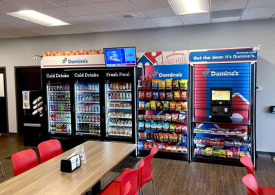 Deluxe micro market installed at Domino’s office with custom shelving and cooler setup