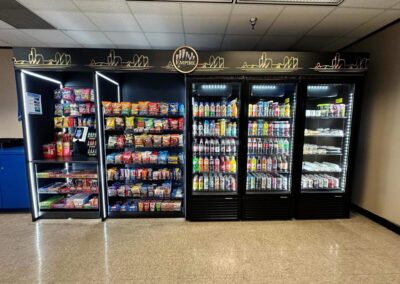 Deluxe micro market unit by Empire Vending with colorful graphic panels and shelves