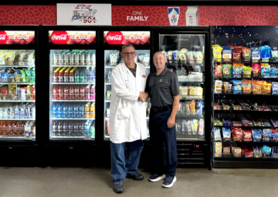 Deluxe micro market for One Family with branded graphic panels and refreshment setup
