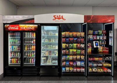 Deluxe micro market setup for SAIA with coolers, snack racks, and corporate branding