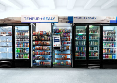 Deluxe micro market unit at Tempur-Sealy with branded cooler walls and snack fixtures