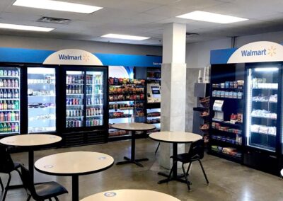 Second Walmart micro market featuring customer seating, vending wall, and product stations