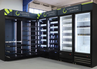 Magnetic header cooler bank with modular shelving in warehouse, great for micro markets, vending machines, and AI coolers